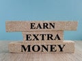 Earn extra money text written on brick blocks. Concept of financial planning Make more extra money from parttime side hustle or Royalty Free Stock Photo