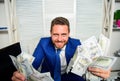 Earn money easy business tips. Man cheerful happy businessman with pile dollar banknotes. Profit and richness concept Royalty Free Stock Photo