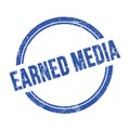 EARNED MEDIA text written on blue grungy round stamp