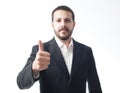 Earnest young businessman showing approval sign. Royalty Free Stock Photo