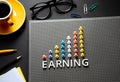 Earning text with pin garph chart on business table.vision to success Royalty Free Stock Photo