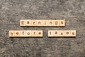 Earnings Before Taxes word written on wood block. abbreviation EBT text on cement table for your desing, concept Royalty Free Stock Photo