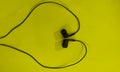 Earphone.Black earphone on Yellow backgroud.