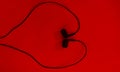 Earphone.Black earphone on Red backgroud.