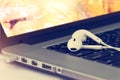 Earphone and laptop and on dark background, Vintage color Royalty Free Stock Photo
