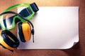 Earphones, goggles and blank paper Royalty Free Stock Photo