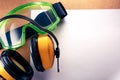 Earphones, goggles and blank paper Royalty Free Stock Photo