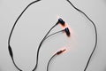 Earphones lying on the gray background. Modern music concept. Audio technology