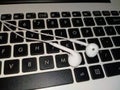 earphones over a white laptop keyboard Royalty Free Stock Photo