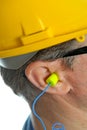 Earplug into the ear Royalty Free Stock Photo