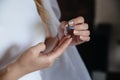 Earring in the hands of the bride Royalty Free Stock Photo