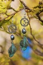 Earrings with burdock leaves Royalty Free Stock Photo