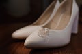 Earrings with pearls on white women& x27;s leather shoes. Bride& x27;s accessories, bride& x27;s morning Royalty Free Stock Photo