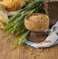 Ears of barley and wheat on the wooden background Royalty Free Stock Photo