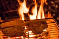 Ears of corn on a grill over high heat, night shooting. Royalty Free Stock Photo