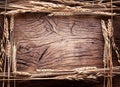 Ears of wheat in the form frame on old wood. Royalty Free Stock Photo