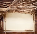 Ears of wheat on old wood. Royalty Free Stock Photo