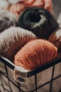 Earth coloured merino wool yarn inside a basket, sunlight, selective focus Royalty Free Stock Photo