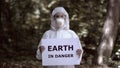 Earth in danger sign in female researcher hands, ecological problem, pollution Royalty Free Stock Photo