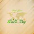Earth Day background with the words, world map and green leaves. Wooden texture. Vector illustration Royalty Free Stock Photo
