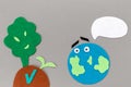 Earth Day concept. Cutted out of felt the planet Earth with emoticon and soil with a plant sprout and tree. Gray background. Flat