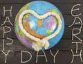 Earth Day concept. Heart knoted with rope lays on globe