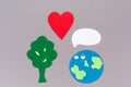 Earth Day. Cutted out of felt the lovely planet Earth with tree and heart. Gray background. Copy space. Flat lay. The concept of