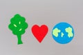 Earth Day. Cutted out of felt soil with a, heart and the planet earth. Gray background. Flat lay. Copy space. The concept of Royalty Free Stock Photo