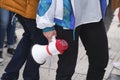 Earth Day demonstration, young person holding a megaphone; activism, protest