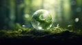 Earth Day, the environment, and a green globe nestled in a forest adorned with moss, defocused abstract sunlight to Royalty Free Stock Photo