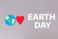 Earth Day. A felt-cut symbol of the planet earth and a red heart. Gray background with text. Flat lay. The concept of Royalty Free Stock Photo