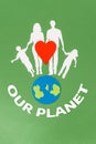 Earth Day. A felt-cut symbol of the planet earth and a red heart with paper silhouette of family. Green background with text. Flat Royalty Free Stock Photo