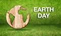Earth day word with wood world globe icon at green grass room,Ecology concept, Leave space for adding your text Royalty Free Stock Photo