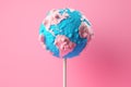 Earth depicted as a lollipop on pink background