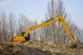 Earth digger, excavator, at the river\'s shore Royalty Free Stock Photo