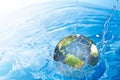 Earth falling into water Royalty Free Stock Photo