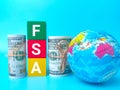 Earth globe and banknotes with word FSA