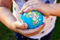 Earth globe in children hands