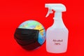 Earth globe model with black surgical mask and 70% alcohol isolated on red background. Royalty Free Stock Photo