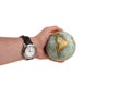 Earth globe shows continent africa in a human hand and the watch shows high time