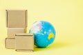 Earth globe is surrounded by boxes. Global business and international transportation of goods products. Shipping freight, world Royalty Free Stock Photo