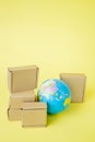 Earth globe is surrounded by boxes. Global business and international transportation of goods products. Shipping freight, world Royalty Free Stock Photo