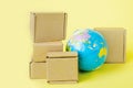 Earth globe is surrounded by boxes. Global business and international transportation of goods products. Shipping freight Royalty Free Stock Photo