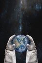 Earth in the hands of astronaut. Earth Day concept.