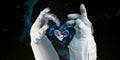 Earth heart in astronaut hands in space background, among stars and galaxies