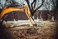 Earth loader, industrial heavy duty excavator moving soil during landscaping works Royalty Free Stock Photo