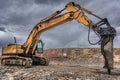 Earth moving by a bulldozer in the construction of a road in Spain. Hydraulic hammer for backhoe