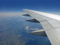 Earth and plane wing view from an illuminator Royalty Free Stock Photo