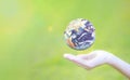 Earth planet globe in hands on green nature background. Environmental protection concept. Elements of this image furnished by Royalty Free Stock Photo