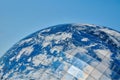 Earth planet modern building with clouds and blue sky, ecological architectural concept Royalty Free Stock Photo